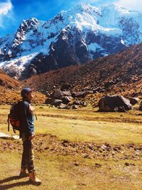 Man standing on landscape against mountain range