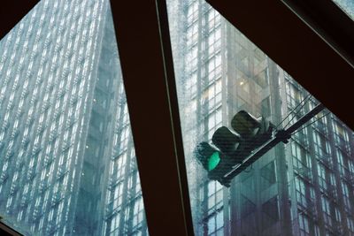 Low angle view of glass window in building