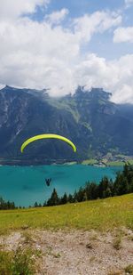 Person paragliding over landscape