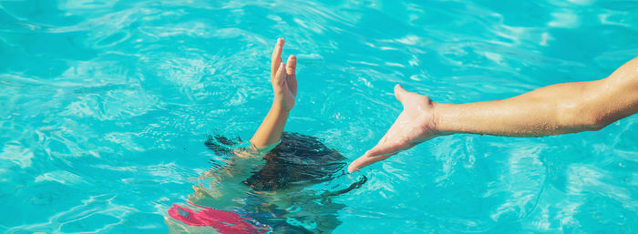 High angle view of woman swimming in pool