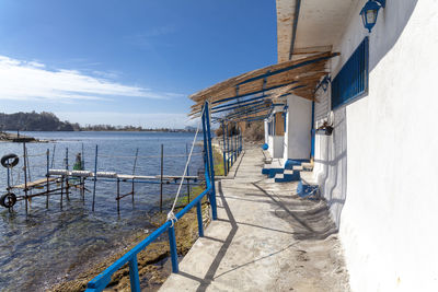 Scenic view of sea by buildings against sky