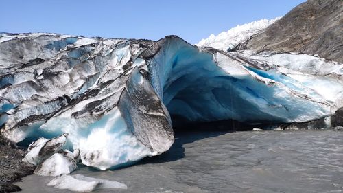 Iceberg on lake against clear sky