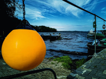 Close-up of boat moored on sea against sky