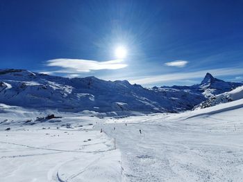 Scenic view of snow covered mountains against sky