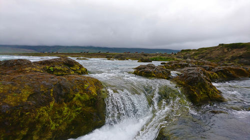 Scenic view of sea and landscape against sky
