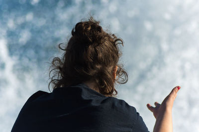 Low angle view of woman in front of sky