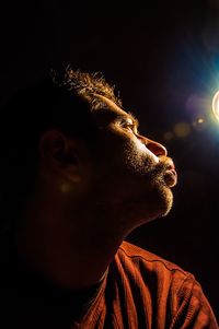 Close-up of young man at night