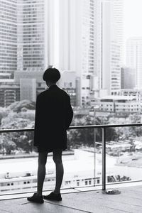 Rear view of woman standing in city