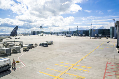 Airplane on airport runway against sky