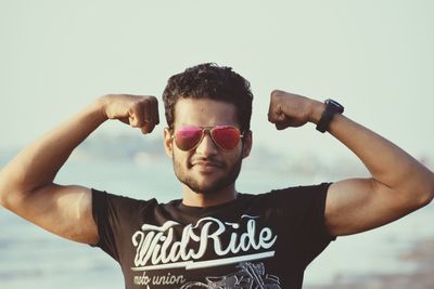 Portrait of man wearing sunglasses standing outdoors