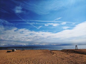 Scenic view of beach against blue sky