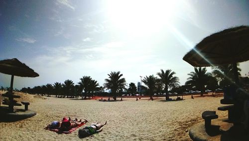 People relaxing on beach