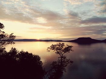 Scenic view of lake against sky during sunset