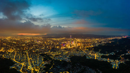 High angle view of city lit up at night