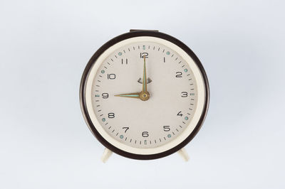 Close-up of clock on white background