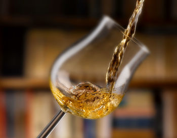 Close-up of wine pouring in glass