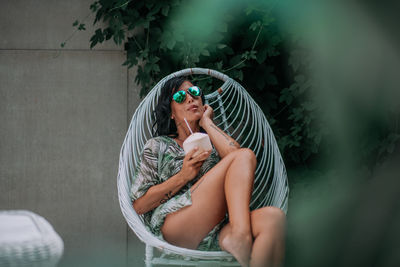 Full length of woman sitting outdoors