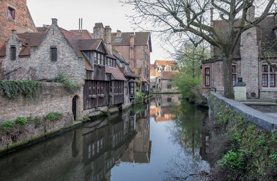 Historical buildings reflected in canal in brugge, belgium.