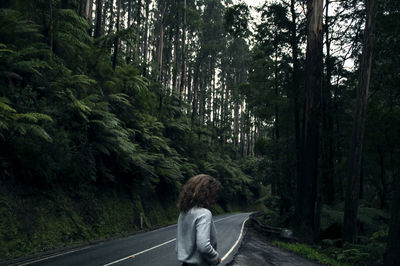 Woman on road in forest