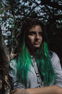 Portrait of beautiful young woman in forest