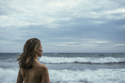 Shirtless woman at beach