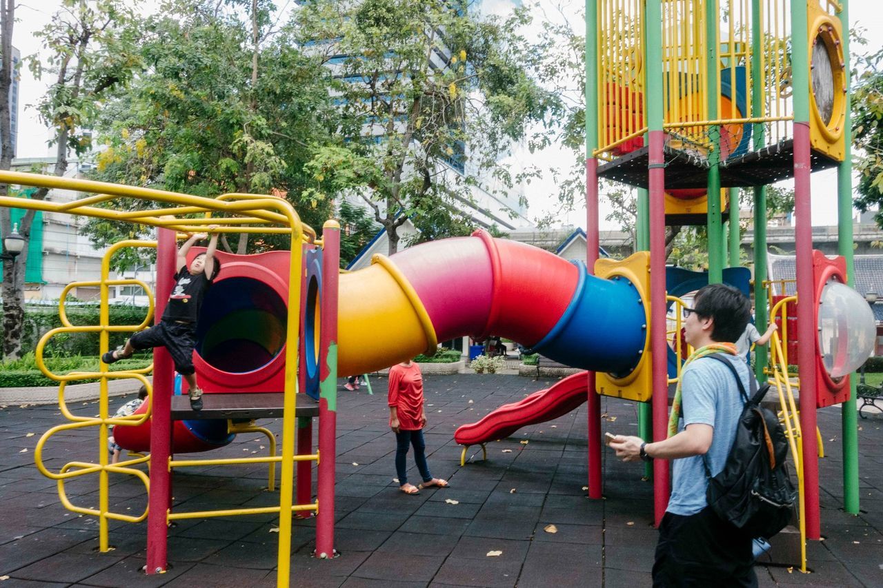 real people, tree, day, men, lifestyles, leisure activity, women, plant, casual clothing, incidental people, side view, people, standing, architecture, nature, childhood, child, two people, outdoors, females, outdoor play equipment