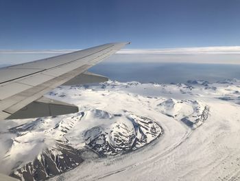 Aerial view of snowcapped mountain against sky