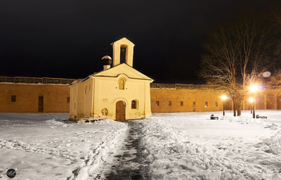 View of illuminated church during winter at night