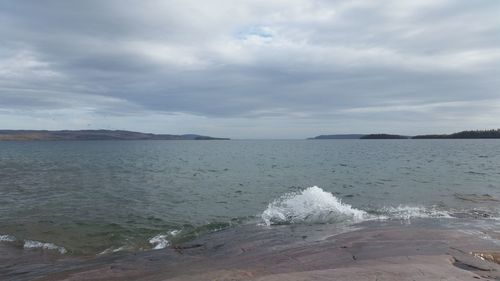 Scenic view of sea against cloudy sky