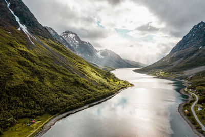 Scenic view of lake amidst mountains against sky