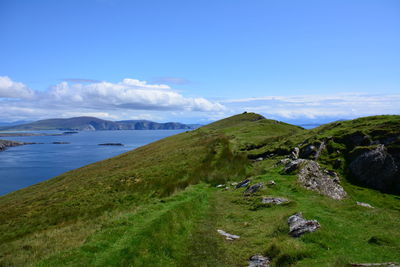 Scenic view of sea and mountains against sky