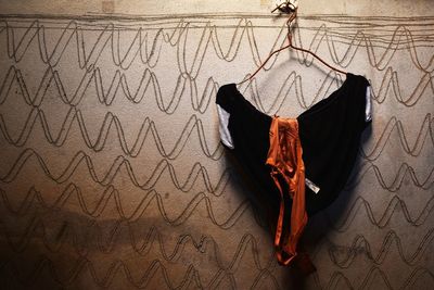 High angle view of black shoes hanging on wall