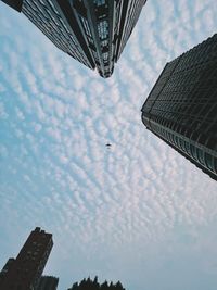 Low angle view of buildings against cloudy sky