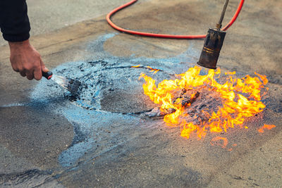 Cropped hand of person welding metal