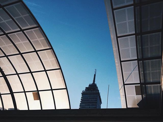 architecture, built structure, building exterior, low angle view, clear sky, tower, city, blue, modern, tall - high, office building, skyscraper, building, glass - material, sky, famous place, capital cities, day, copy space, travel destinations