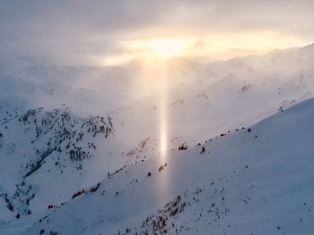 Scenic view of snowcapped mountains against sky during sunset