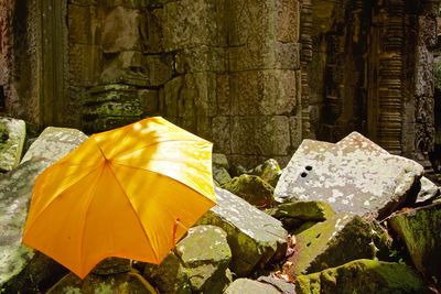 Yellow umbrella at old ruin angkor wat temple