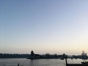 Scenic view of river against clear sky during sunset