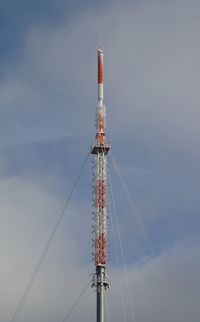 Low angle view of communications tower against sky