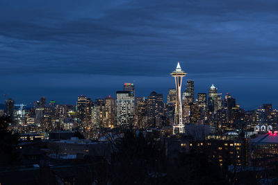 Illuminated cityscape against sky at night