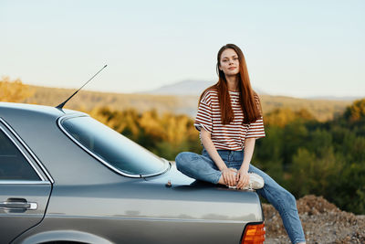 Low angle view of woman standing on road