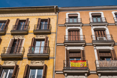 Low angle view of yellow building against sky