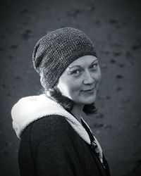 Portrait of smiling woman wearing knit hat outdoors