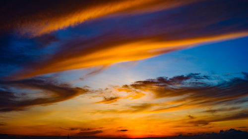 Low angle view of dramatic sky during sunrise