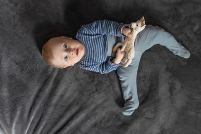 Directly above shot of baby lying on bed at home