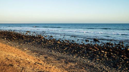 Scenic view of beach against clear sky