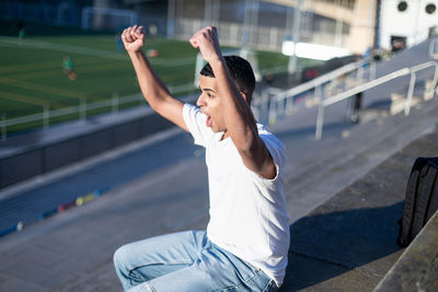 Full length of young man exercising in gym