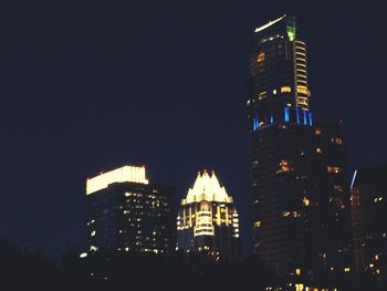 Low angle view of illuminated buildings at night