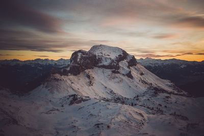 Scenic view of dramatic sky over mountains during sunset