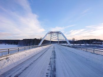 Snow covered bridge against sky